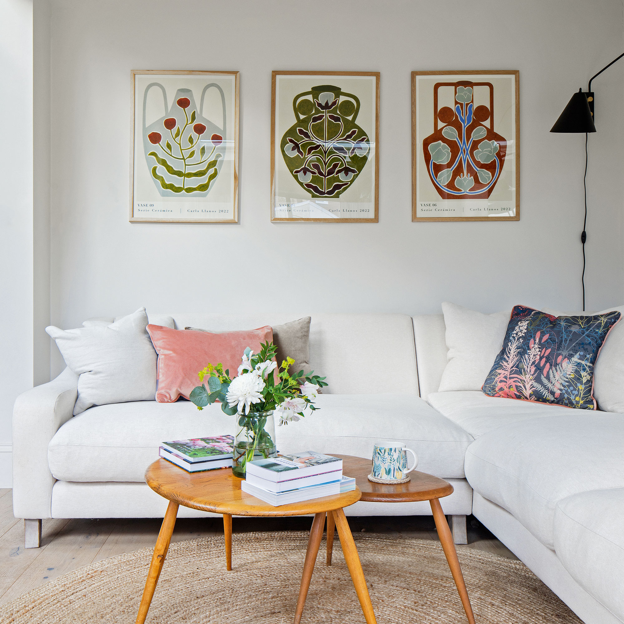 White living room with white sofa and colourful wall art