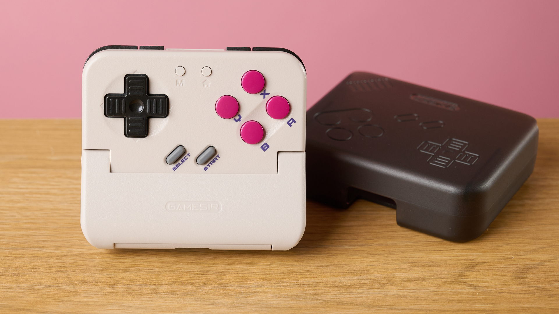 The GameSir Pocket Taco straight on propped up next to its carry case.