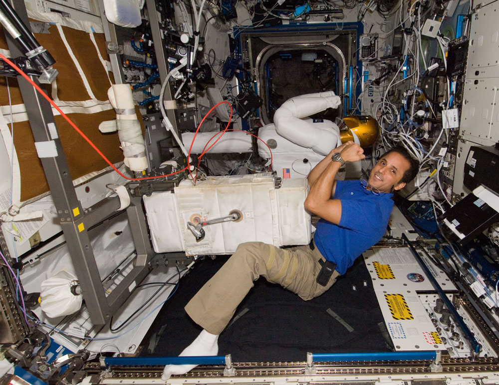 NASA astronaut Joe Acaba, Expedition 31 flight engineer, poses for a photo with Robonaut 2 humanoid robot in the Destiny laboratory of the International Space Station in June 2012.