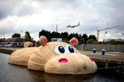 Dutch artist puts giant inflatable hippo in the River Thames
