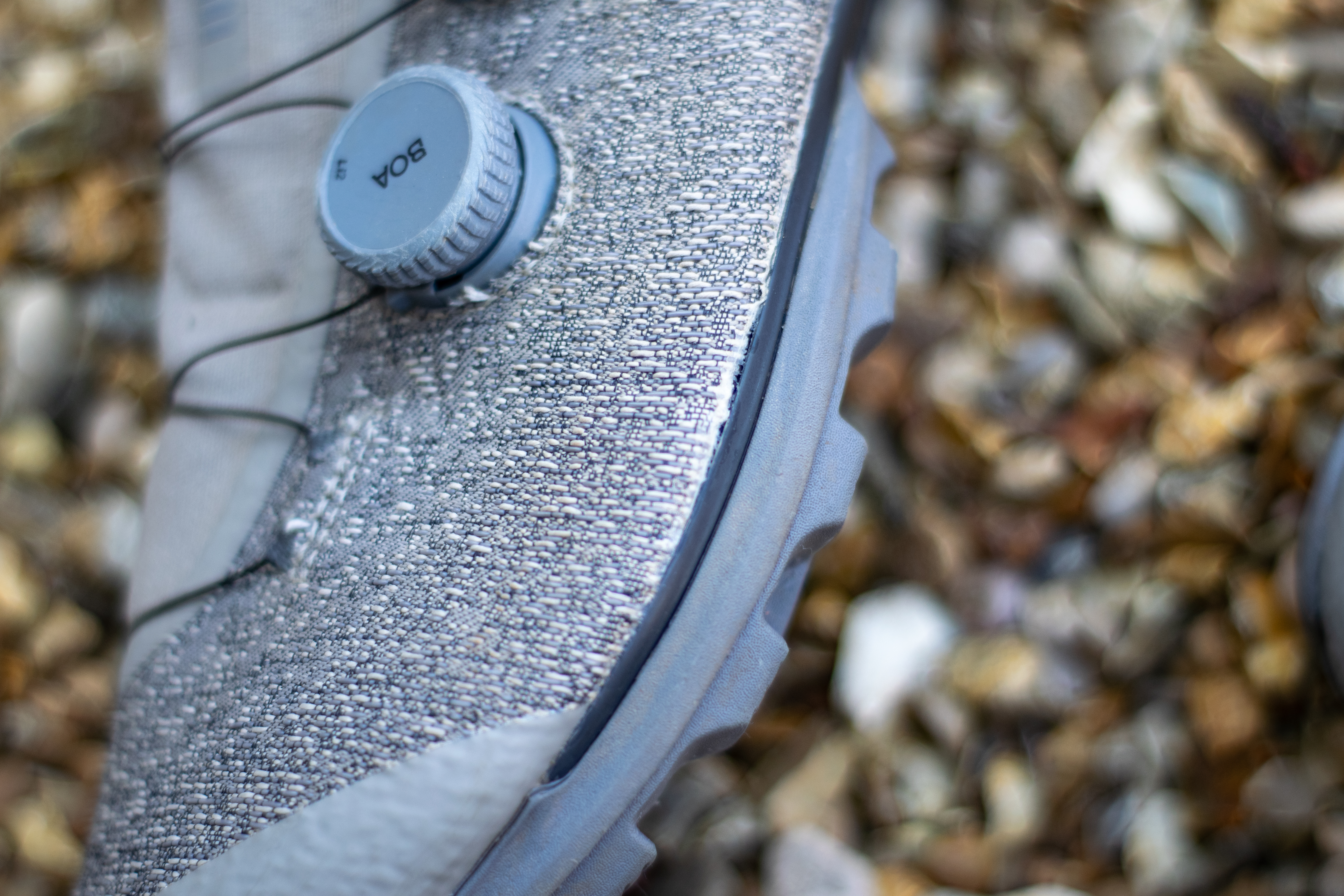 A pair of Rapha Pro Team Gravel shoes on some gravel