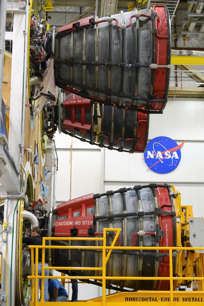 The third RS-25 rocket engine is seen attached to the core stage of NASA's first Space Launch System rocket.