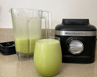 Green smoothie in glass made using KitchenAid K150 blender