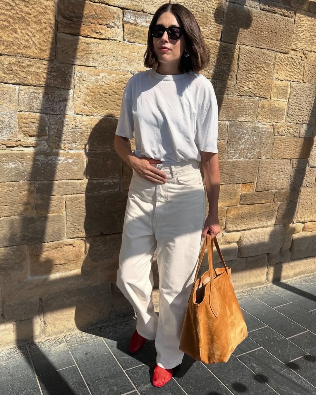 @lucyalston_ Wearing a red mesh flat with ecru jeans, a white t-shirt and a tan suede tote