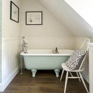 attic bathroom with wooden floor and frame on wall