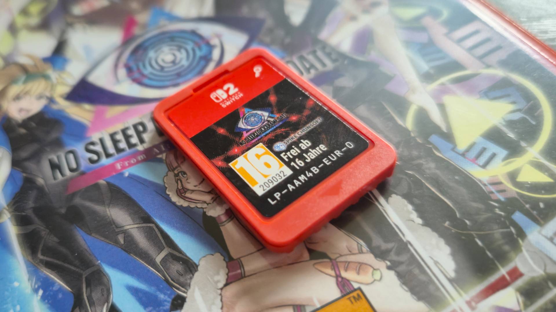 Photo by Rosalie Newcombe of a close-up of the Game-Key Card of No Sleep For Kaname Date sitting on its physical Switch 2 game box.
