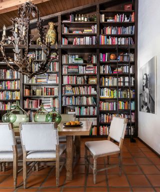 Dining room with floor to ceiling bookshelves filled with cookbooks
