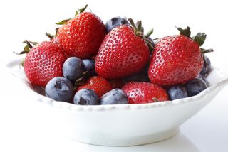 A bowl of blueberries and strawberries.