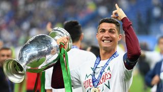PARIS, FRANCE - JULY 10: Cristiano Ronaldo of Portugal holds the Henri Delaunay trophy to celebrate after his team's 1-0 win against France in the UEFA EURO 2016 Final match between Portugal and France at Stade de France on July 10, 2016 in Paris, France. (Photo by Mike Hewitt/Getty Images)