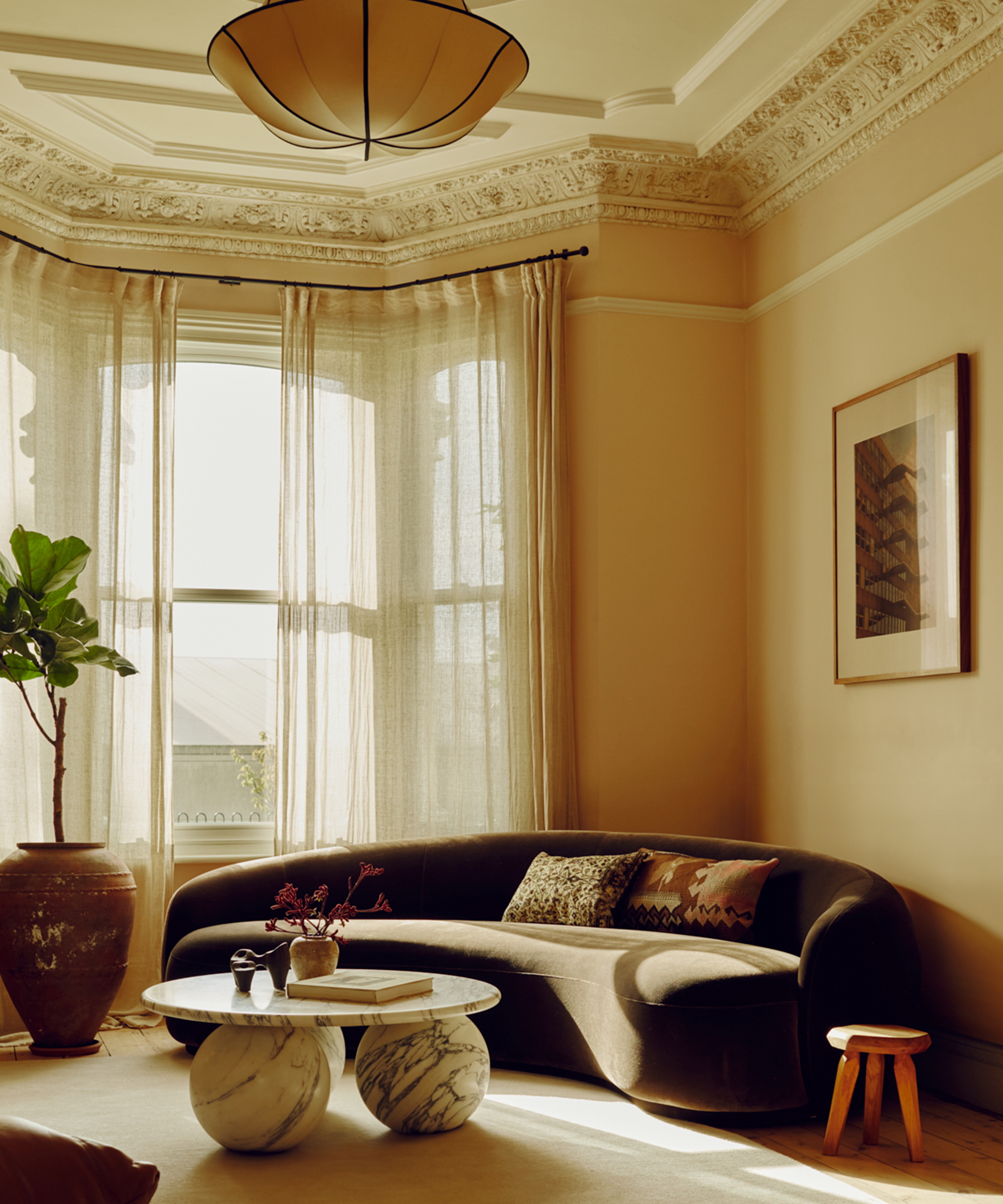 living room with curved sofa and round coffee table