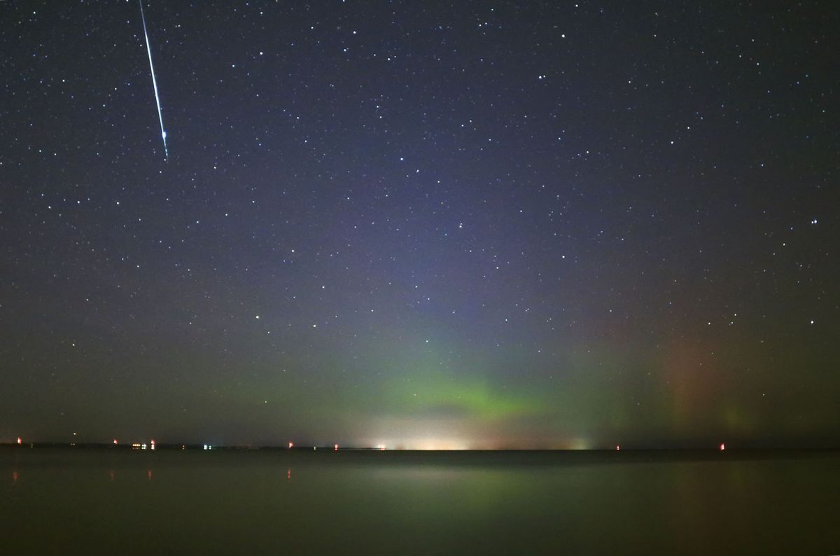 A Taurid fireball descends in glowing aurora over Lake Simcoe in southern Ontario, Canada, on Nov. 9, 2015.