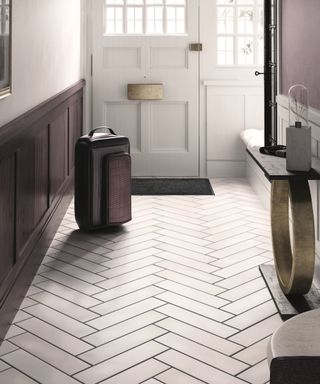 white porcelain tiles and dark purple wall paneling in a hallway