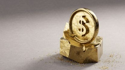 Gold coin with dollar sign sitting on top of a rough hewn chunk of solid gold.