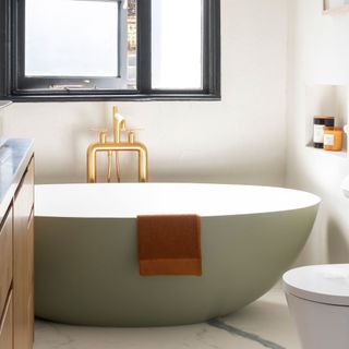 green freestanding tub in modern bathroom