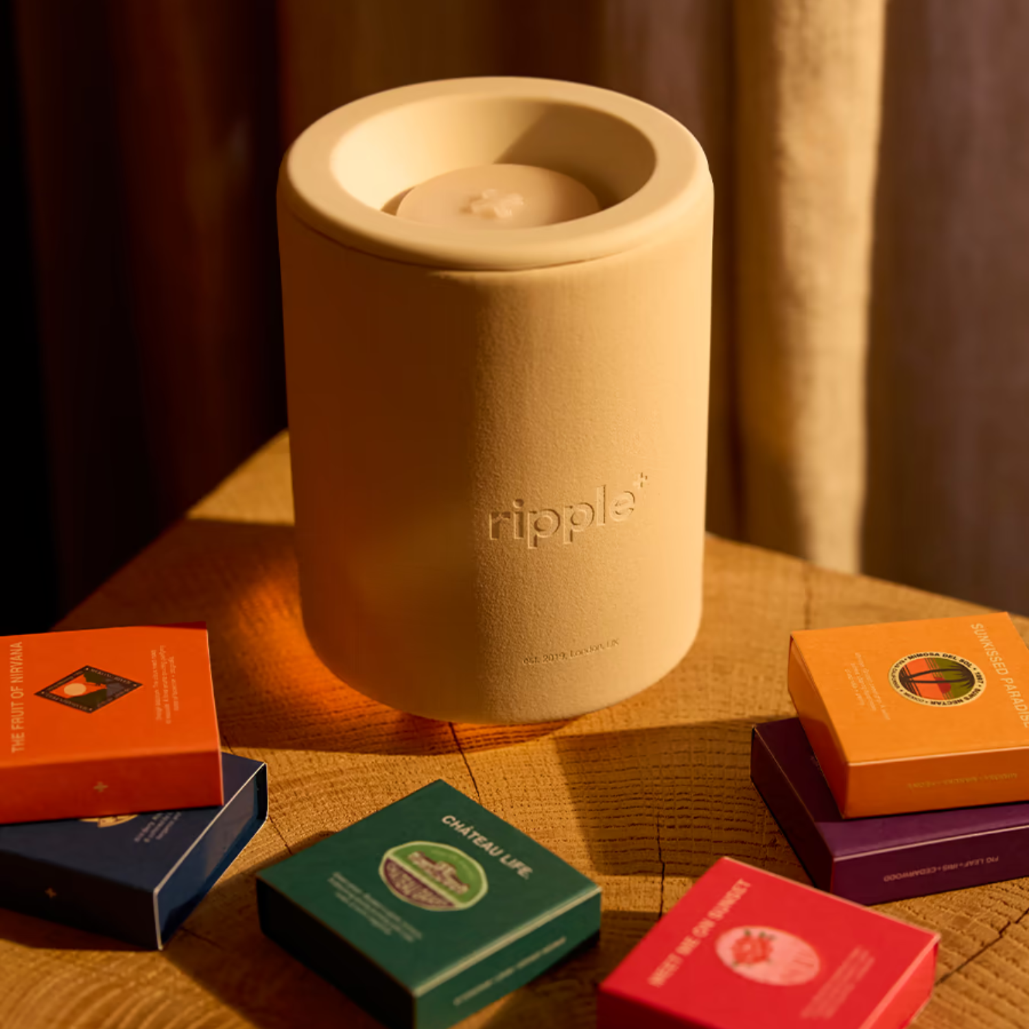 A yellow wax warmer on a side table with packaged wax tablets