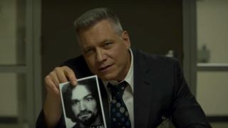 Holt McCallany holding up photograph in Netflix's Mindhunter