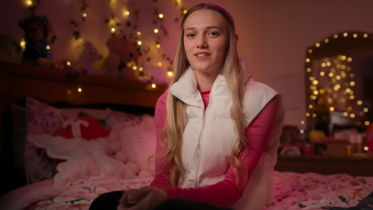 Lauryn Licari sitting on a bed being interviewed for Unknown Caller: The High School Catfish