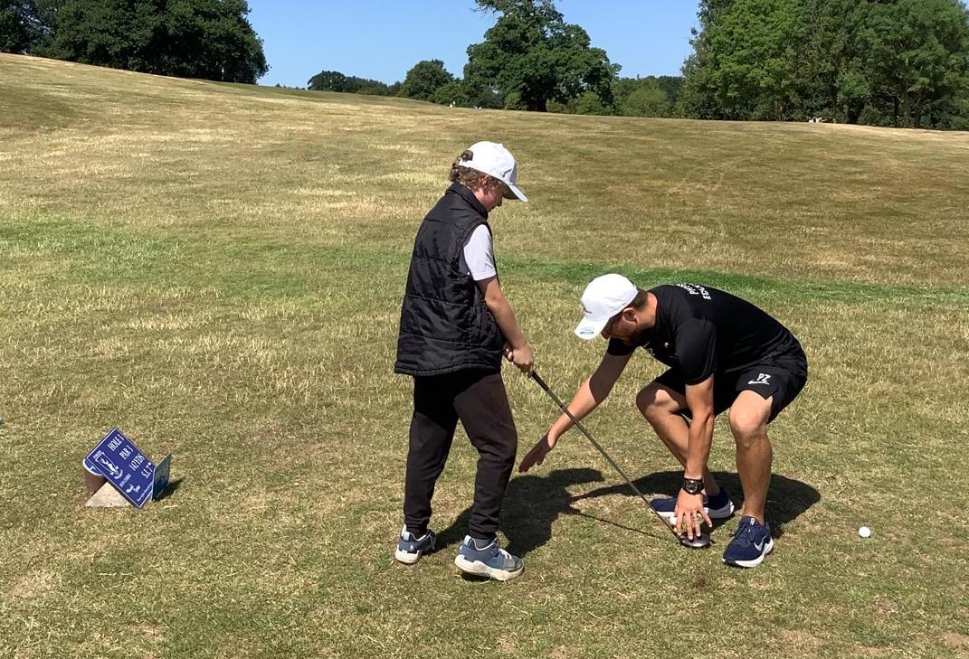 A golfer getting a lesson on the course