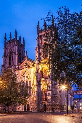 York Minster, the cathedral of the city of York, floodlit at twilight.