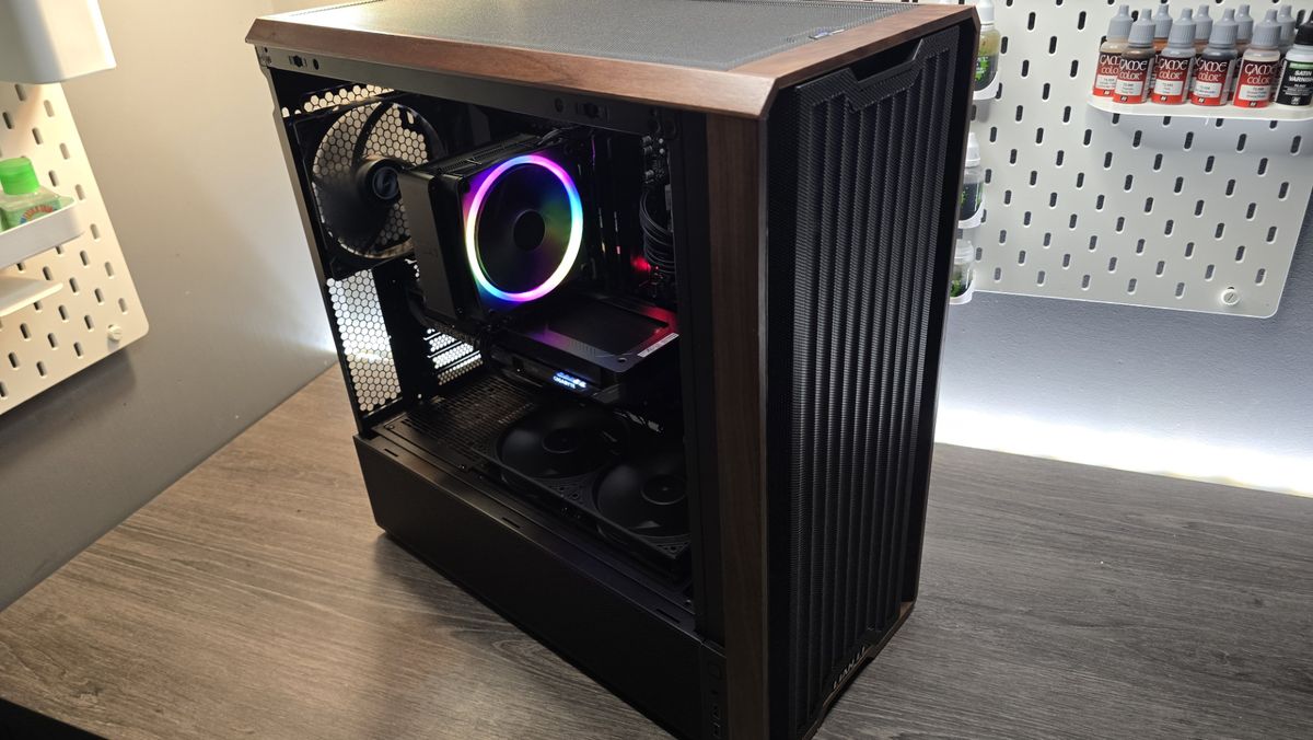 A Lian Li Lancool 217 on a desk with various components installed inside it.