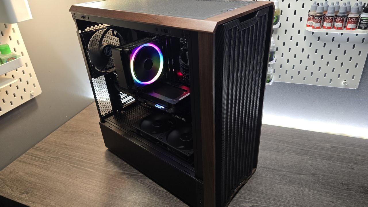 A Lian Li Lancool 217 on a desk with various components installed inside it.