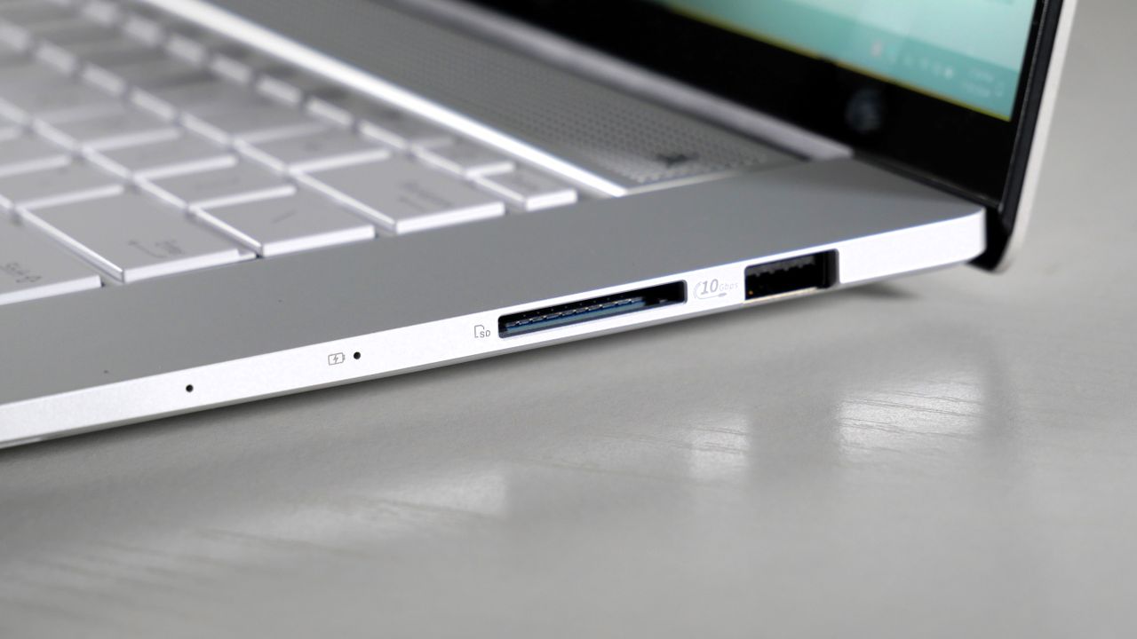 Asus Zenbook S16 UM5606 (Ryzen AI 9) open on a white desk showing the ports on its right side.