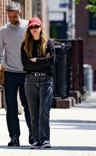 Jennifer Lawrence wearing all black with a red hat in New York City April 2024