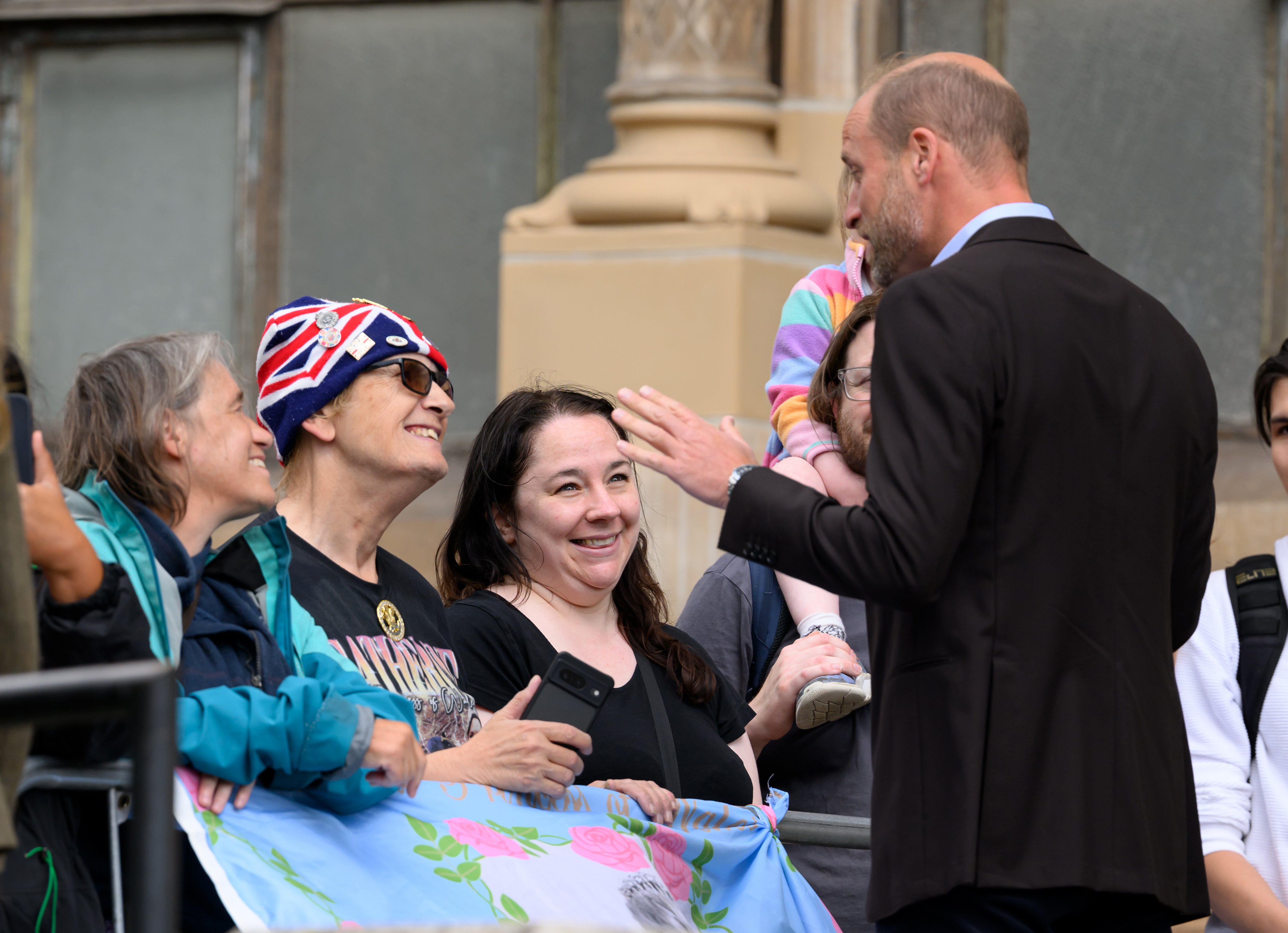 Prince William talking to fans outside a museum