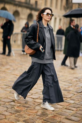 Woman wearing white sneakers and gray outfit