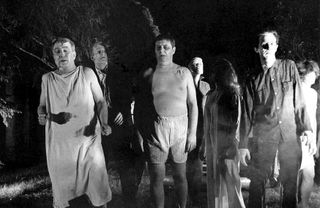 a group of zombies walking together in the original night of the living dead