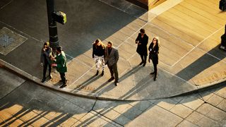 Group of people standing on a pavement corner