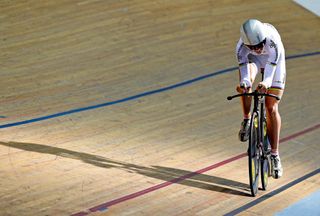 World individual pursuit champion Joanna Rowsell passes through a window of late afternoon sunlight during qualifying at the National Track Championships in Manchester.