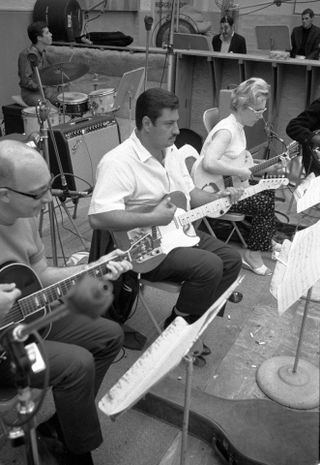 Tommy Tedesco (center) playing guitar with Carol Kaye playing guitar (on right) of the Wrecking Crew