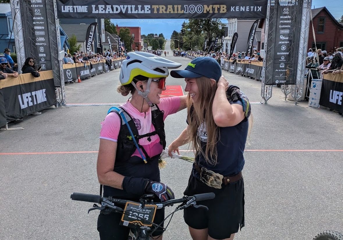 Melisa Rollins (right) winner of 2024 Leadville Trail 100 MTB, greets her mother Lisa Nelson at the finish line