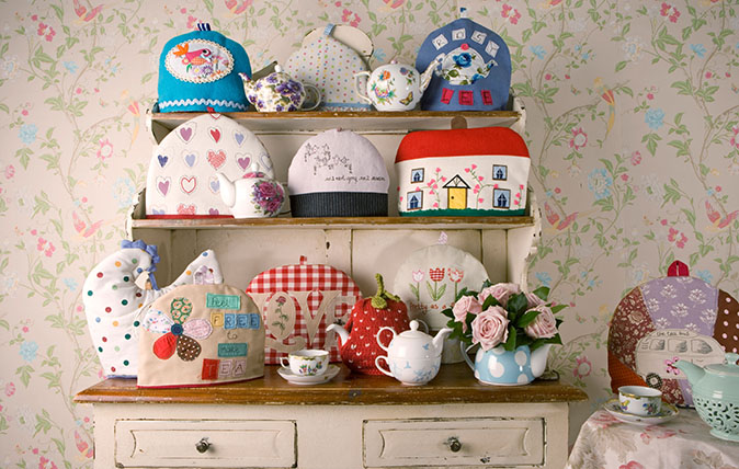 A collection of Tea Cosies on a Welsh Dresser