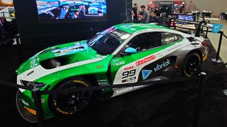 A photo of a BMW M4 GT3 race car on the Fanatec booth at the Sim Racing Expo.