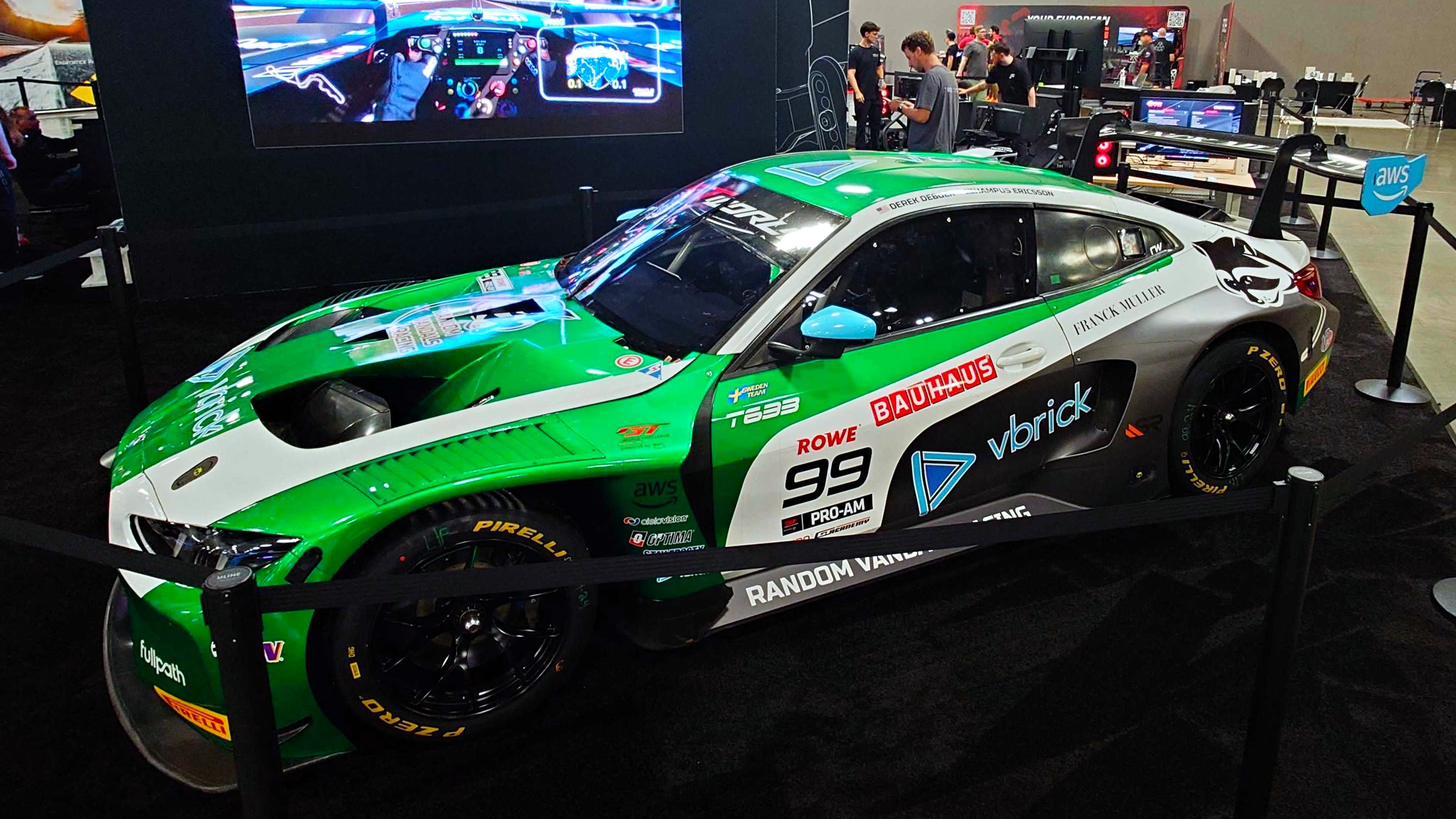 A photo of a BMW M4 GT3 race car on the Fanatec booth at the Sim Racing Expo.