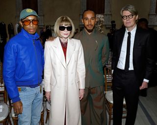 Pharrell Williams, Anna Wintour, Lewis Hamilton, and the Met Costume Institute director standing in the Met museum