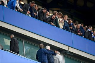 Todd Boehly, Chairman of Chelsea, speaks to fans during the Premier League match between Chelsea FC and Brighton & Hove Albion at Stamford Bridge on April 15, 2023 in London, England