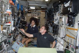 Williams and Malenchenko Work at ISS Zvezda Service Module