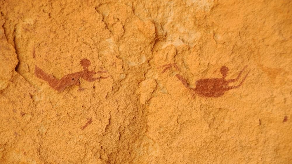 Rock art paintings depicting two people swimming. 