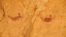 Rock art paintings depicting two people swimming. 