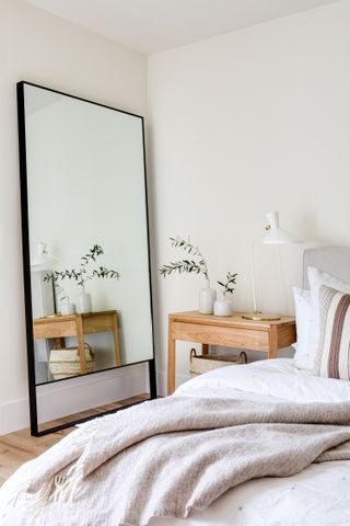 Bedroom with mirror next to the bed