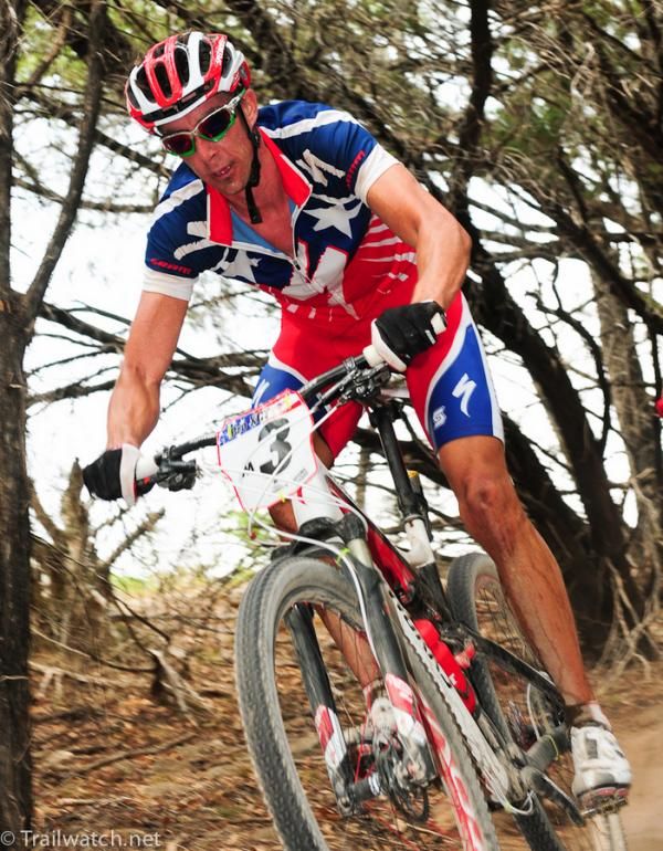 Todd Wells (Specialized) descending through the trees with a small lead