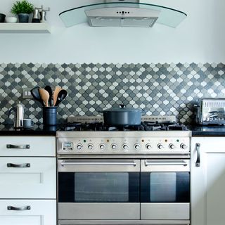 kitchen room with oven and wall tiles