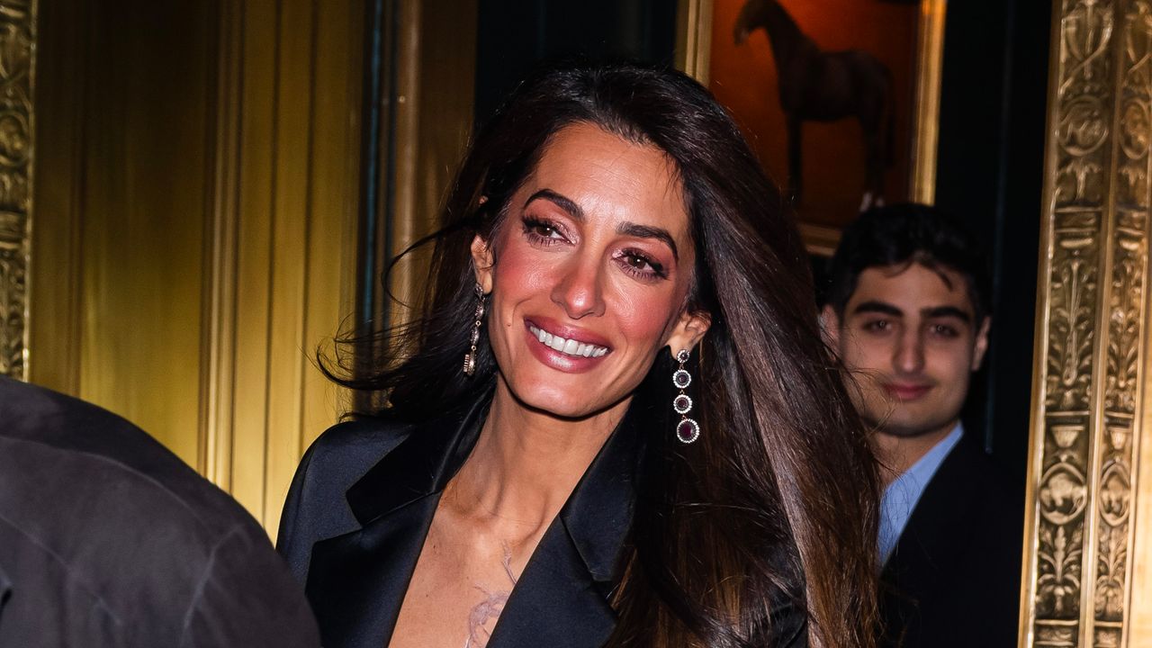 George Clooney and Amal Clooney leave the Polo Bar on December 14, 2023 in New York City. 