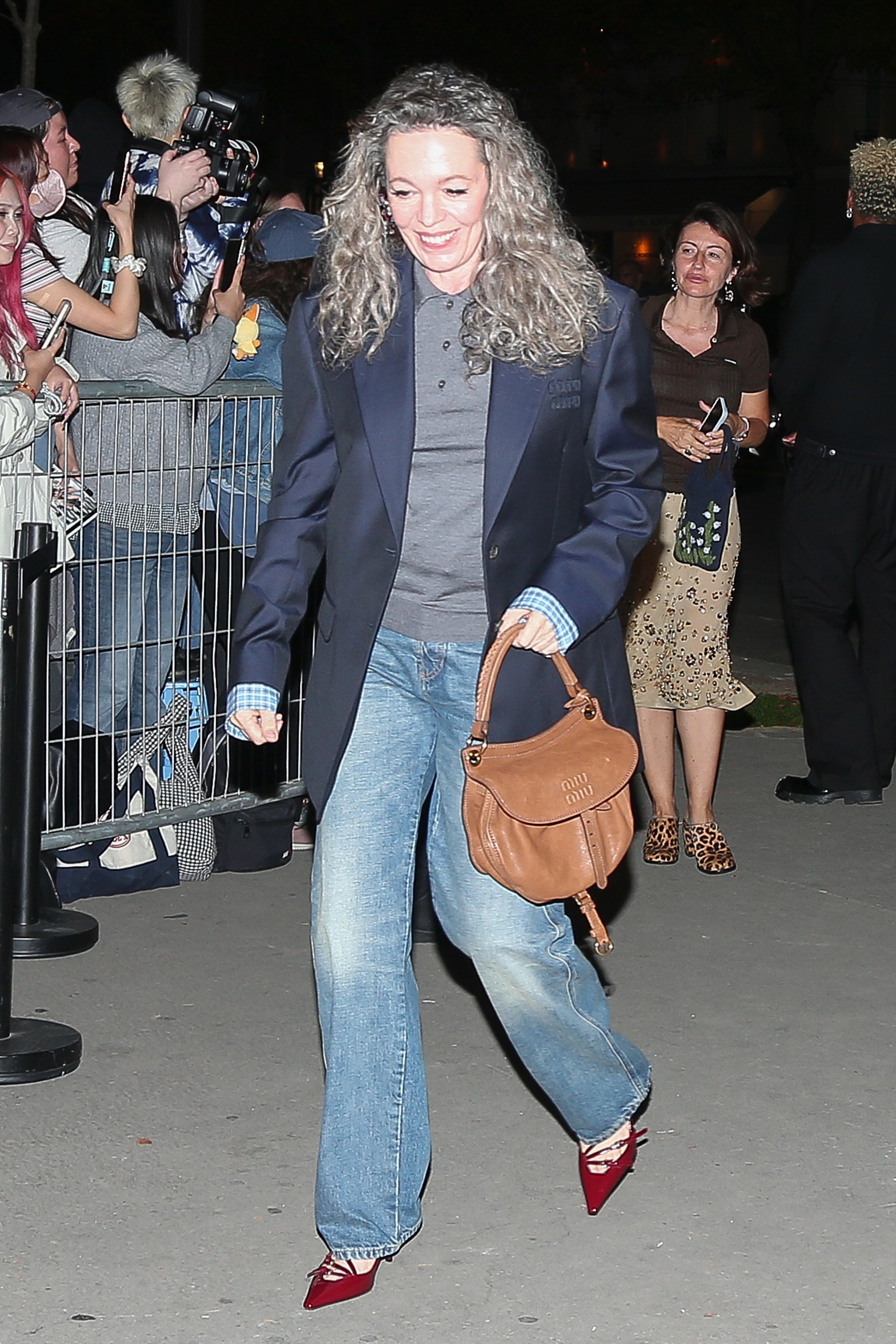 Olivia Colman wearing jeans, blazer and red heels as she arrives at Miu Miu's Paris Fashion Week after party on October 4, 2026 in Paris, France