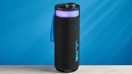 the jlab go party speaker in black with an LED RGB panel and jlab logo photographed in front of a blue background