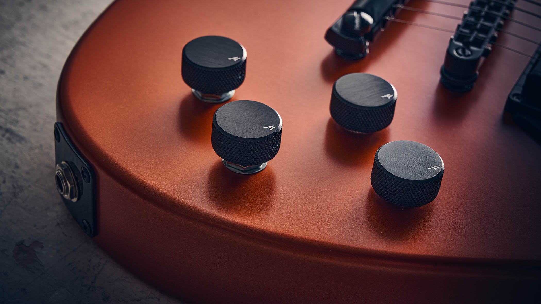 Manson MD-3 Mikey Demus Signature: the hot-orange T-style is photographed against a distressed grey-white background