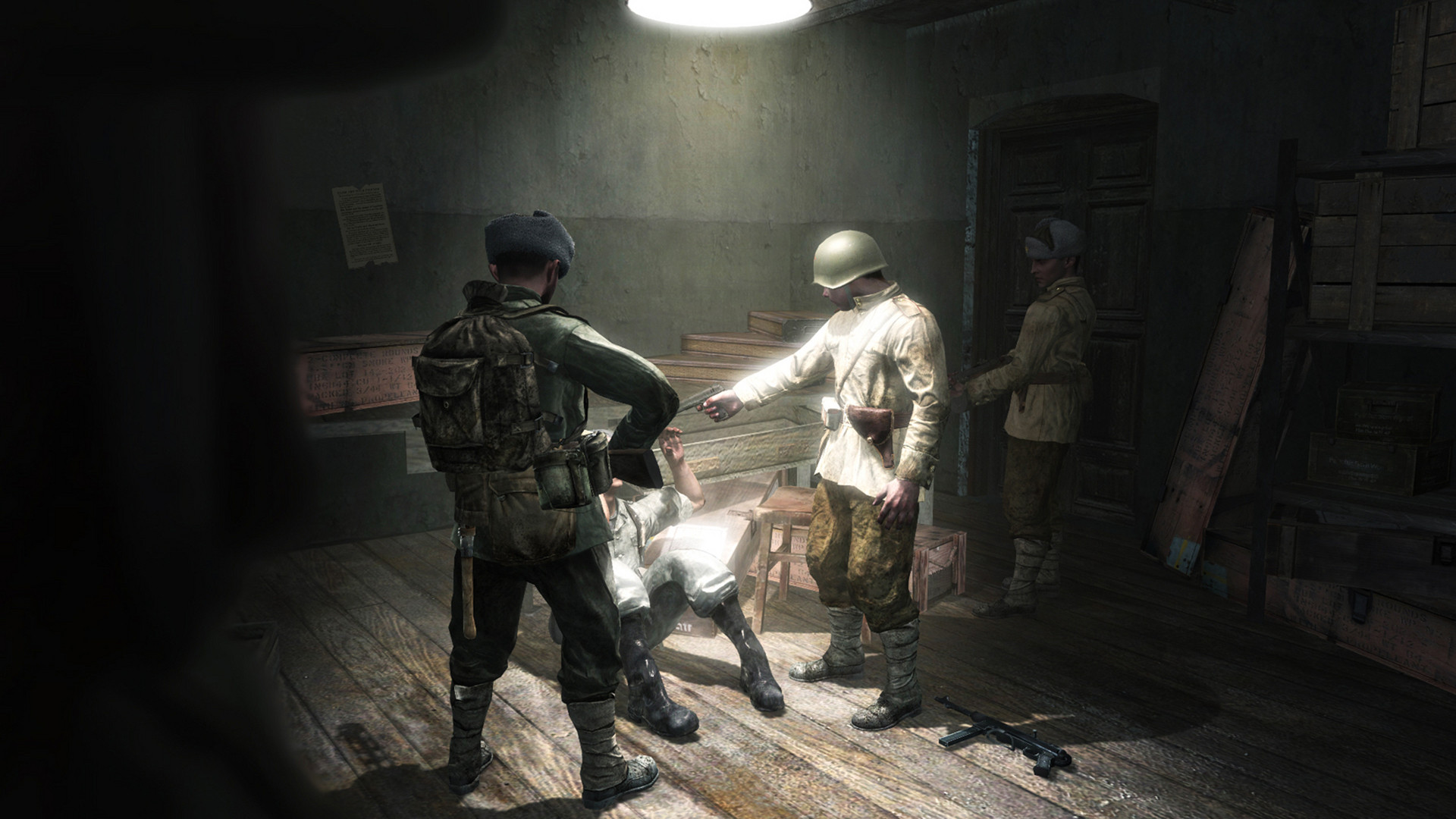 Black Ops games in order: A man being held at gun point in a room during Call of Duty World At War.